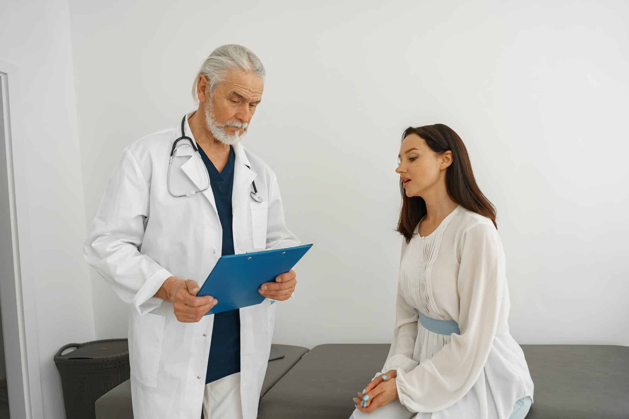 therapist conducts a preventive examination of a woman